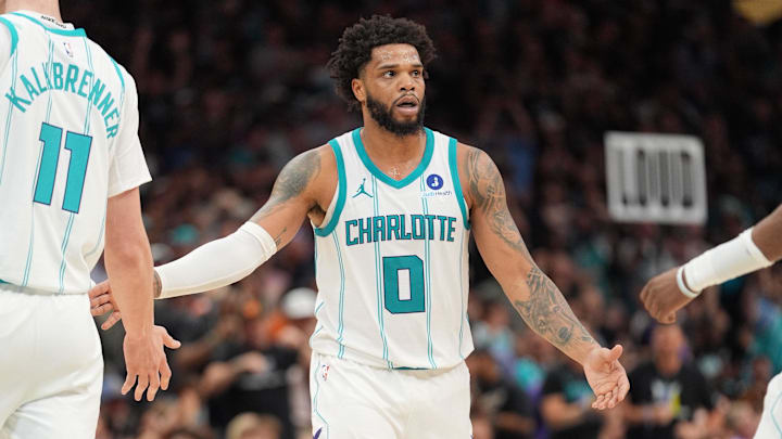 Apr 14, 2026; Charlotte, North Carolina, USA; Charlotte Hornets forward Miles Bridges (0) high fives center Ryan Kalkbrenner (11) and forward Brandon Miller (24) after a three point play during the second half during the play-in rounds between the Charlotte Hornets and the Miami Heat of the 2026 NBA Playoffs at Spectrum Center. Mandatory Credit: Jim Dedmon-Imagn Images
