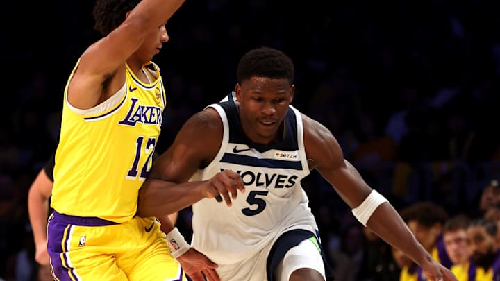 Oct 22, 2024; Los Angeles, California, USA; Minnesota Timberwolves guard Anthony Edwards (5) drives against Los Angeles Lakers guard Max Christie (12) during the fourth quarter at Crypto.com Arena. Mandatory Credit: Jason Parkhurst-Imagn Images