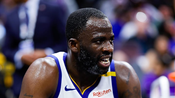 Green sits on the bench during a game. 