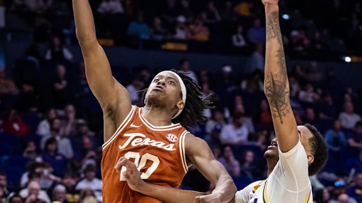 Feb 1, 2025; Baton Rouge, Louisiana, USA;  Texas Longhorns guard Tre Johnson (20) drives to the basket against LSU Tigers guard Vyctorius Miller (0) during the second half at Pete Maravich Assembly Center. Mandatory Credit: Stephen Lew-Imagn Images
