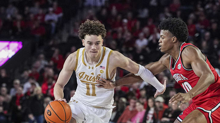Dec 3, 2024; Athens, Georgia, USA; Notre Dame Fighting Irish guard Braeden Shrewsberry (11) dribbles against Georgia Bulldogs forward RJ Godfrey (10) during the second half at Stegeman Coliseum. Mandatory Credit: Dale Zanine-Imagn Images