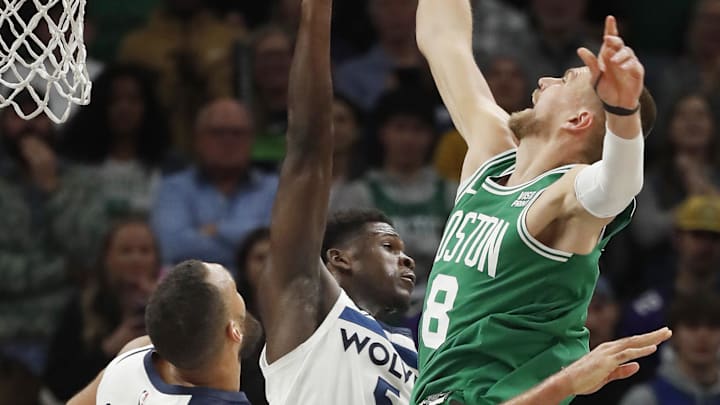Nov 6, 2023; Minneapolis, Minnesota, USA; Boston Celtics center Kristaps Porzingis (8) goes to the basket against Minnesota Timberwolves center Rudy Gobert (27) and forward Kyle Anderson (5) in overtime at Target Center. Mandatory Credit: Bruce Kluckhohn-Imagn Images