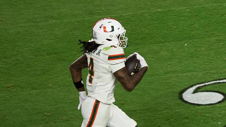 Jan 19, 2026; Miami Gardens, FL, USA; Miami Hurricanes running back Mark Fletcher Jr. (4) carries the ball for a touchdown against the Indiana Hoosiers in the third quarter during the College Football Playoff National Championship game at Hard Rock Stadium. Mandatory Credit: Kim Klement Neitzel-Imagn Images