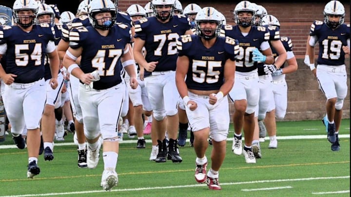 Walker Valley High School's Center/IOL Andrew Duggan (55) leads his team onto the field with same passion he plays the game. Walker Valley High School's Center/IOL Andrew Duggan (55) leads his team onto the field with same passion he plays the game.
