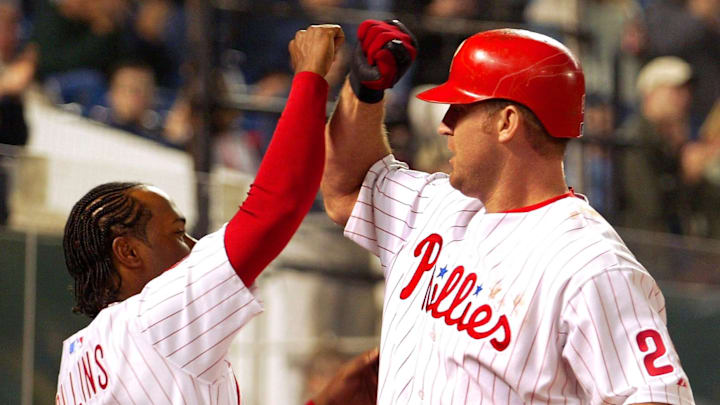 The Philadelphia Phillies' Jimmy Rollins congratulates teammate Jim Thome after a home run.