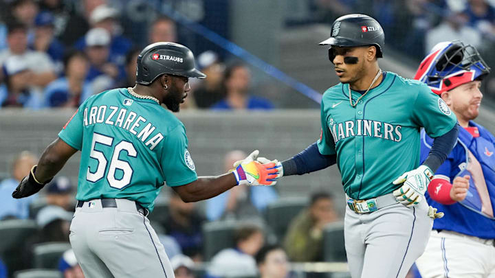 Oct 13, 2025; Toronto, Ontario, CAN; Seattle Mariners infielder Jorge Polanco (7) celebrates a three run home run with outfielder Randy Arozarena (56) in the fifth inning against the Toronto Blue Jays during game two of the ALCS round for the 2025 MLB playoffs at Rogers Centre. Mandatory Credit: Nick Turchiaro-Imagn Images