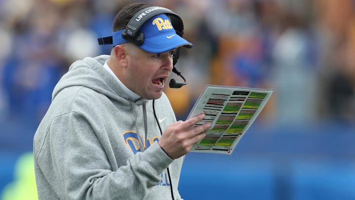 Nov 16, 2024; Pittsburgh, Pennsylvania, USA;  Pittsburgh Panthers offensive coordinator Cade Bell looks over his play chart against the Clemson Tigers during the fourth quarter at Acrisure Stadium. Mandatory Credit: Charles LeClaire-Imagn Images