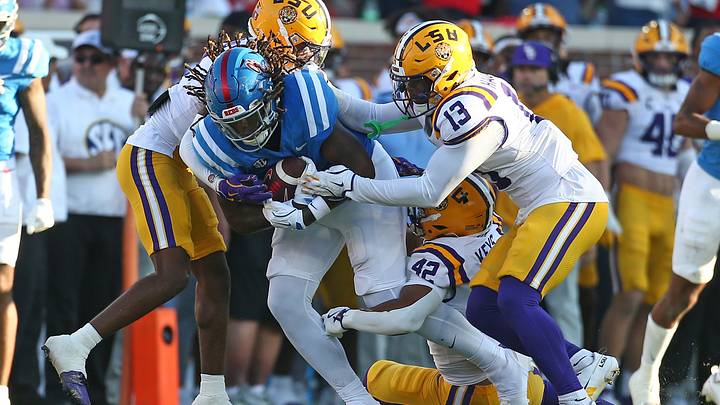 Sep 27, 2025; Oxford, Mississippi, USA; Mississippi Rebels tight end Dae'Quan Wright (8) runs after a catch as LSU Tigers cornerback PJ Woodland (11), linebacker Davhon Keys (42) and safety A.J. Haulcy (13) attempt to make the tackle during the third quarter at Vaught-Hemingway Stadium. Mandatory Credit: Petre Thomas-Imagn Images Sep 27, 2025; Oxford, Mississippi, USA; Mississippi Rebels tight end Dae'Quan Wright (8) runs after a catch as LSU Tigers cornerback PJ Woodland (11), linebacker Davhon Keys (42) and safety A.J. Haulcy (13) attempt to make the tackle during the third quarter at Vaught-Hemingway Stadium. Mandatory Credit: Petre Thomas-Imagn Images