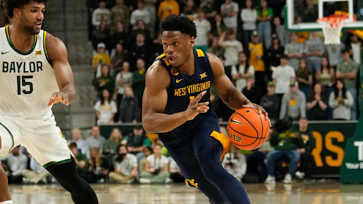Feb 15, 2025; Waco, Texas, USA; West Virginia Mountaineers guard Joseph Yesufu (1) drives to the basket ahead of Baylor Bears forward Norchad Omier (15) during the first half at Paul and Alejandra Foster Pavilion. Mandatory Credit: Chris Jones-Imagn Images