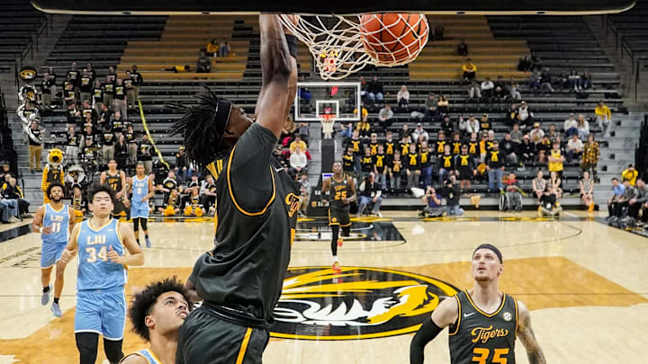 Dec 14, 2024; Columbia, Missouri, USA; Missouri Tigers guard Anthony Robinson II (0) dunks the ball as LIU Sharks guard Blake Lander (2) looks on during the first half at Mizzou Arena. Mandatory Credit: Denny Medley-Imagn Images Dec 14, 2024; Columbia, Missouri, USA; Missouri Tigers guard Anthony Robinson II (0) dunks the ball as LIU Sharks guard Blake Lander (2) looks on during the first half at Mizzou Arena. Mandatory Credit: Denny Medley-Imagn Images