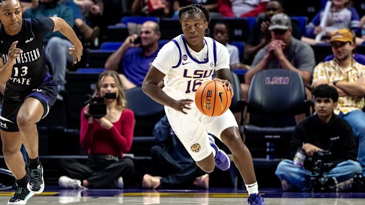 Nov 8, 2024; Baton Rouge, Louisiana, USA;  LSU Lady Tigers guard Kailyn Gilbert (16) brings the ball up court against Northwestern State Lady Demons guard Nia Hardison (13) during the first half at Pete Maravich Assembly Center. Mandatory Credit: Stephen Lew-Imagn Images
