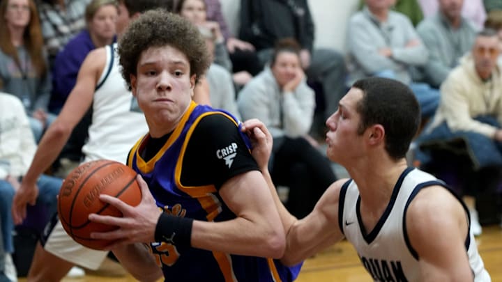 St. Rose's Jayden Hodge (#33) drives around Manasquan's Brandon Kunz (#5) during their game in Belmar Wednesday evening, January 22, 2025.