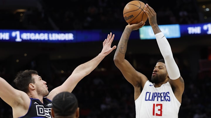 Feb 2, 2024; Detroit, Michigan, USA;  LA Clippers forward Paul George (13) shoots on Detroit Pistons forward Danilo Gallinari (12) in the first half at Little Caesars Arena. Mandatory Credit: Rick Osentoski-Imagn Images