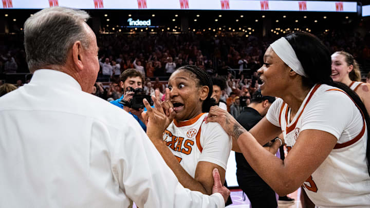 Texas Longhorns forwards Madison Booker (35) and forward Aaliyah Moore (23) celebrate their 80-76 win over the Tennessee Lady Vols with head coach Vic Schaefer in the Moody Center, Jan. 23, 2025. Texas Longhorns forwards Madison Booker (35) and forward Aaliyah Moore (23) celebrate their 80-76 win over the Tennessee Lady Vols with head coach Vic Schaefer in the Moody Center, Jan. 23, 2025.