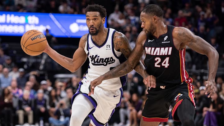 Jan 6, 2025; Sacramento, California, USA; Sacramento Kings guard Malik Monk (0) drives to the basket against Miami Heat forward Haywood Highsmith (24) during overtime at Golden 1 Center. Mandatory Credit: Ed Szczepanski-Imagn Images