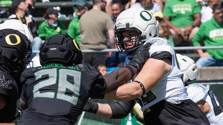 Oregon’s Anthony Jones Jr., left, and offensive lineman Fox Crader, right, square off during the Oregon Spring Game at Autzen Stadium in Eugene April 25, 2026
