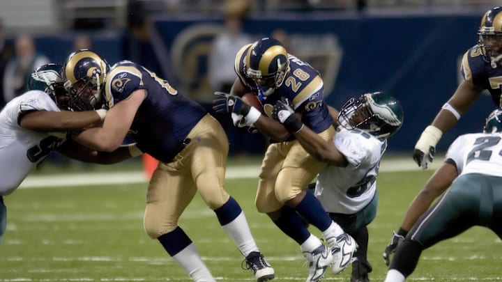 December 18, 2005; St. Louis, MO, USA; St. Louis Rams running back Marshall Faulk (28) attempts to get away from Philadelphia Eagles linebacker Trent Cole (58) at the Edward Jones Dome in the fourth quarter. Faulk surpassed Marcus Allen for 9th place on the NFL's all-time rushing list. Mandatory Credit: Photo by Scott Rovak-Imagn Images December 18, 2005; St. Louis, MO, USA; St. Louis Rams running back Marshall Faulk (28) attempts to get away from Philadelphia Eagles linebacker Trent Cole (58) at the Edward Jones Dome in the fourth quarter. Faulk surpassed Marcus Allen for 9th place on the NFL's all-time rushing list. Mandatory Credit: Photo by Scott Rovak-Imagn Images