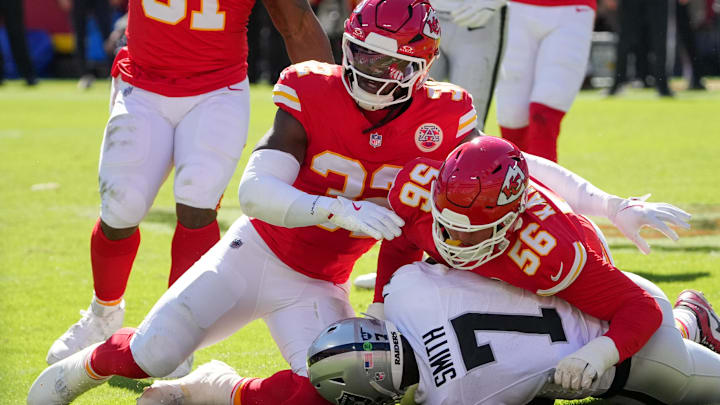 Oct 19, 2025; Kansas City, Missouri, USA; Kansas City Chiefs defensive end George Karlaftis (56) and linebacker Nick Bolton (32) tackle Las Vegas Raiders quarterback Geno Smith (7) during the second quarter of the game at GEHA Field at Arrowhead Stadium. Mandatory Credit: Denny Medley-Imagn Images