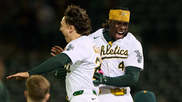 Apr 12, 2024; Oakland, California, USA; Oakland Athletics second baseman Zack Gelof (20) and outfielder Lawrence Butler (4) leap and celebrate a walk-off win against the Washington Nationals in the tenth inning at Oakland-Alameda County Coliseum. Mandatory Credit: Robert Edwards-Imagn Images Apr 12, 2024; Oakland, California, USA; Oakland Athletics second baseman Zack Gelof (20) and outfielder Lawrence Butler (4) leap and celebrate a walk-off win against the Washington Nationals in the tenth inning at Oakland-Alameda County Coliseum. Mandatory Credit: Robert Edwards-Imagn Images