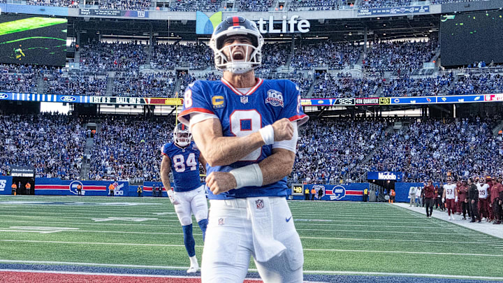 Nov 3, 2024; East Rutherford, New Jersey, USA; New York Giants quarterback Daniel Jones (8) celebrates after scoring a 2nd half touchdown against the Washington Commanders at MetLife Stadium. Mandatory Credit: Robert Deutsch-Imagn Images