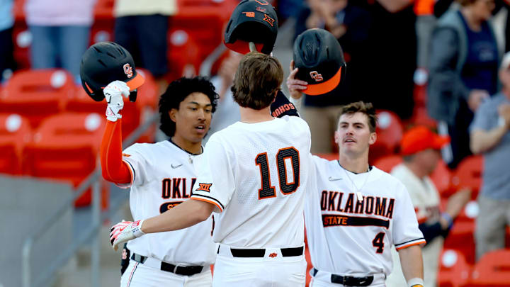 Oklahoma State's Nolan Schubart (10) celebrates a home run with Donovan LaSalle (19) and Zach Ehrhard (4) in the first inning during the college Bedlam baseball game between Oklahoma State University Cowboys and the University of Oklahoma Sooners at O'Brate Stadium in Stillwater, Okla., Friday, April 5, 2024.