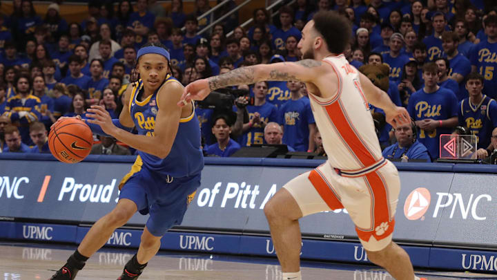 Jan 18, 2025; Pittsburgh, Pennsylvania, USA; Pittsburgh Panthers guard Jaland Lowe (15) dribbles the ball as Clemson Tigers guard Jaeden Zackery (11) defends during the first half at the Petersen Events Center. Mandatory Credit: Charles LeClaire-Imagn Images
