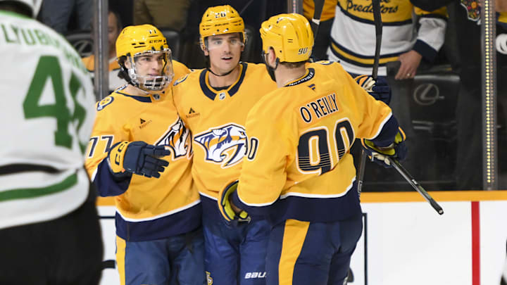 Apr 16, 2025; Nashville, Tennessee, USA;  Nashville Predators defenseman Justin Barron (20) celebrates his goal with his teammates against the Dallas Stars during the first period at Bridgestone Arena. Mandatory Credit: Steve Roberts-Imagn Images