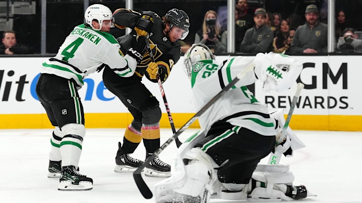 Jan 28, 2025; Las Vegas, Nevada, USA; The stick of Dallas Stars defenseman Miro Heiskanen (4) is loose as goaltender Jake Oettinger (29) makes a save against Vegas Golden Knights right wing Jonas Rondbjerg (46) during the second period at T-Mobile Arena. Mandatory Credit: Stephen R. Sylvanie-Imagn Images