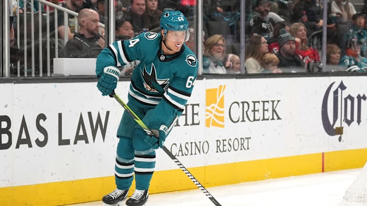 Jan 4, 2025; San Jose, California, USA; San Jose Sharks center Mikael Granlund (64) skates with the puck against the New Jersey Devils during the first period at SAP Center at San Jose. Mandatory Credit: Darren Yamashita-Imagn Images