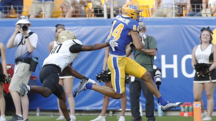 Sep 2, 2023; Pittsburgh, Pennsylvania, USA; Pittsburgh Panthers wide receiver Jake McConnachie (84) scores a touchdown ahead of Wofford Terriers defensive back Eli Campbell (30) during the fourth quarter at Acrisure Stadium. Pittsburgh won 45-7. Mandatory Credit: Charles LeClaire-Imagn Images Sep 2, 2023; Pittsburgh, Pennsylvania, USA; Pittsburgh Panthers wide receiver Jake McConnachie (84) scores a touchdown ahead of Wofford Terriers defensive back Eli Campbell (30) during the fourth quarter at Acrisure Stadium. Pittsburgh won 45-7. Mandatory Credit: Charles LeClaire-Imagn Images
