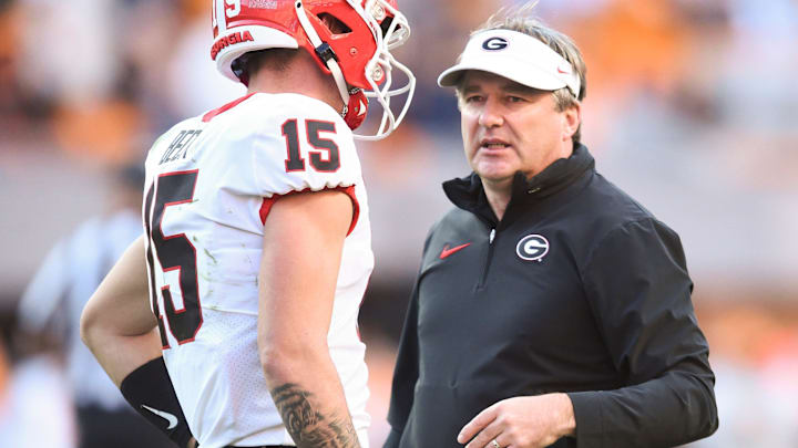Georgia head coach Kirby Smart talks with Georgia quarterback Carson Beck (15) during a football