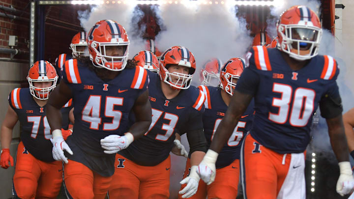 Aug 29, 2025; Champaign, Illinois, USA;  Illinois Fighting Illini players take the field before the start of an NCAA game with the Western Illinois Leathernecks at Memorial Stadium. Mandatory Credit: Ron Johnson-Imagn Images