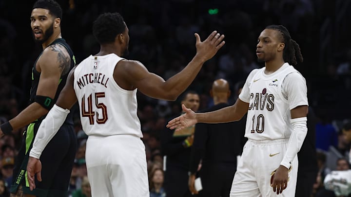 Cleveland Cavaliers guard Donovan Mitchell and guard Darius Garland congratulate each other as Boston Celtics forward Jayson Tatum looks back during the second half at TD Garden. 