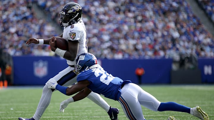 Oct 16, 2022; East Rutherford, New Jersey, USA; Baltimore Ravens quarterback Lamar Jackson (8) runs with the ball against New York Giants cornerback Adoree' Jackson (22) during the third quarter at MetLife Stadium. Mandatory Credit: Brad Penner-Imagn Images