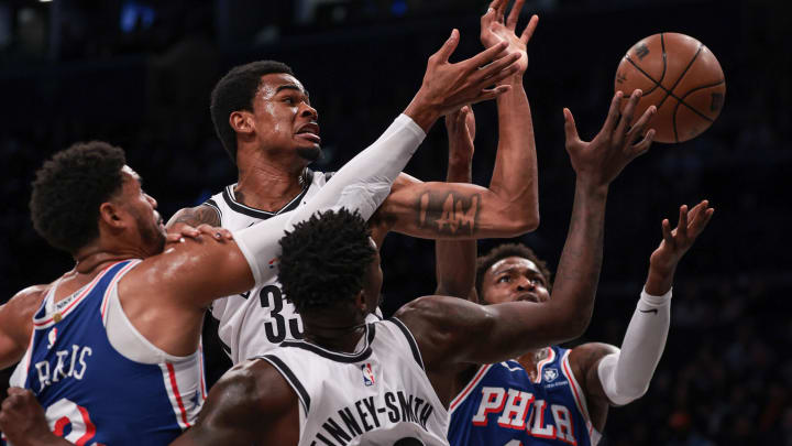 Oct 16, 2023; Brooklyn, New York, USA; Brooklyn Nets center Nic Claxton (33) battles Philadelphia 76ers forward Tobias Harris (12) and forward Paul Reed (44) for a rebound in front of forward Dorian Finney-Smith (28) during the first quarter at Barclays Center. Mandatory Credit: Vincent Carchietta-USA TODAY Sports