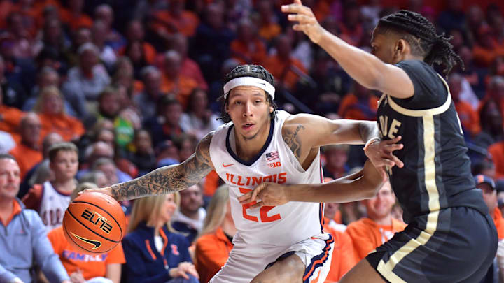 Mar 7, 2025; Champaign, Illinois, USA;  Illinois Fighting Illini guard Tre White (22) drives the ball against Purdue Boilermakers guard C.J. Cox (0) during the first half at State Farm Center. Mandatory Credit: Ron Johnson-Imagn Images