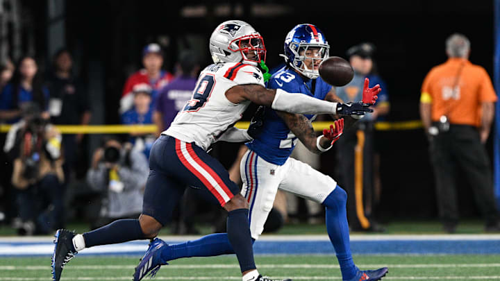Aug 21, 2025; East Rutherford, New Jersey, USA; New York Giants wide receiver Jalin Hyatt (13) fights for a catch against New England Patriots cornerback Kobee Minor (19) during the second quarter at MetLife Stadium. Mandatory Credit: Mark Smith-Imagn Images