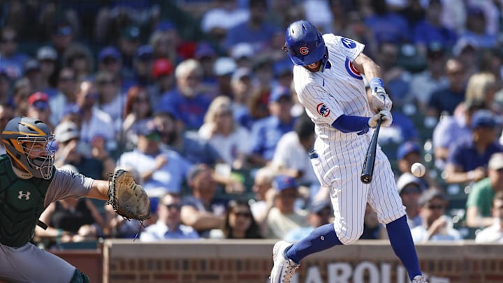 Sep 18, 2024; Chicago, Illinois, USA; Chicago Cubs shortstop Dansby Swanson (7) singles against the Oakland Athletics during the third inning at Wrigley Field.