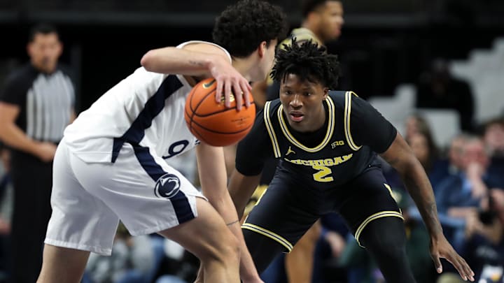 Michigan Wolverines guard LJ Cason defends Penn State Nittany Lions guard Melih Tunca