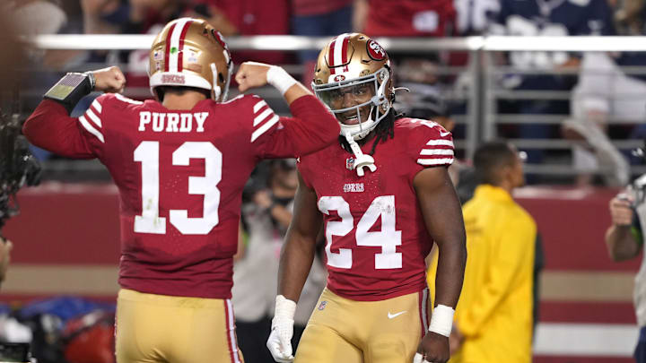 San Francisco 49ers running back Jordan Mason (24) with quarterback Brock Purdy (13)