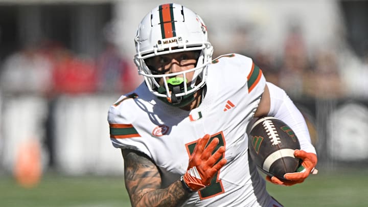 Oct 19, 2024; Louisville, Kentucky, USA;   Miami Hurricanes wide receiver Xavier Restrepo (7) runs the ball against the Louisville Cardinals during the first half at L&N Federal Credit Union Stadium. Miami defeated Louisville 52-45. 