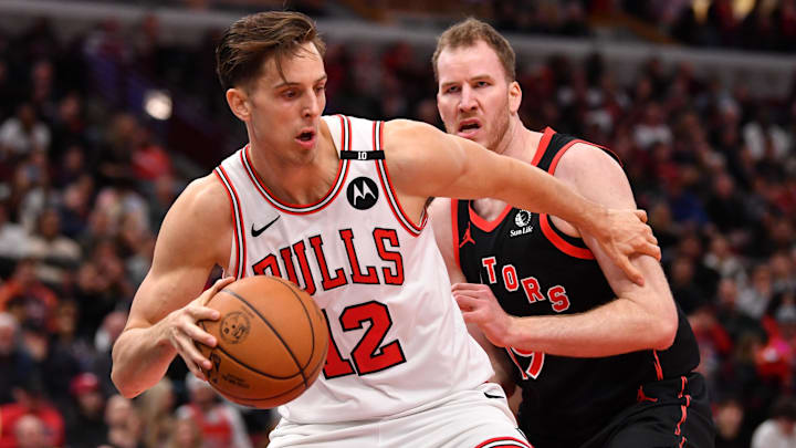 Feb 28, 2025; Chicago, Illinois, USA; Chicago Bulls center Zach Collins (12) controls the ball against the Toronto Raptors center Jakob Poeltl (19) during the second half at the United Center. Mandatory Credit: Patrick Gorski-Imagn Images