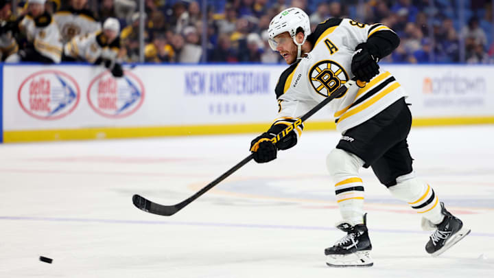 Apr 6, 2025; Buffalo, New York, USA;  Boston Bruins right wing David Pastrnak (88) takes a shot on goal during the third period against the Buffalo Sabres at KeyBank Center. Mandatory Credit: Timothy T. Ludwig-Imagn Images