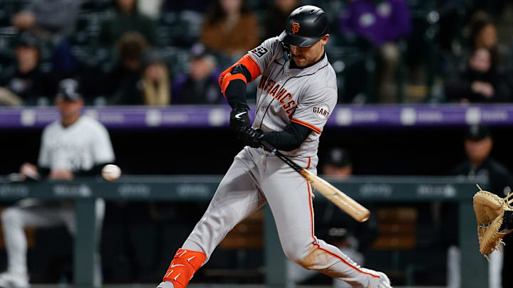 May 7, 2024; Denver, Colorado, USA; San Francisco Giants left fielder Michael Conforto (8) hits an RBI single in the seventh inning against the Colorado Rockies at Coors Field. Mandatory Credit: Isaiah J. Downing-Imagn Images