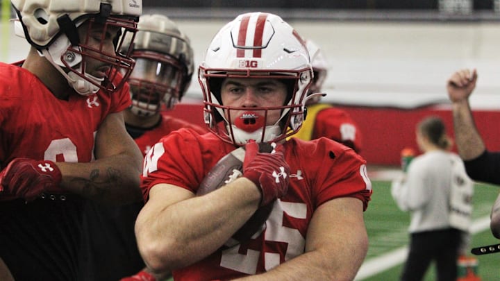Wisconsin running back Cade Yacamelli protects the ball during a drill during practice at the McClain Center in Madison, Wisconsin on Tuesday April 23, 2024.