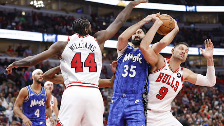 Orlando Magic center Goga Bitadze (35) battles for the ball with Chicago Bulls forward Patrick Williams (44) and center Nikola Vucevic (9) during the second half at United Center. Orlando Magic center Goga Bitadze (35) battles for the ball with Chicago Bulls forward Patrick Williams (44) and center Nikola Vucevic (9) during the second half at United Center.