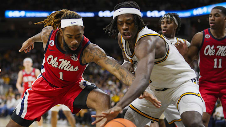 Jan 25, 2025; Columbia, Missouri, USA; Mississippi Rebels forward Mikeal Brown-Jones (1) and Missouri Tigers guard Mark Mitchell (25) fight for a loose ball during the second half at Mizzou Arena. Mandatory Credit: Jay Biggerstaff-Imagn Images