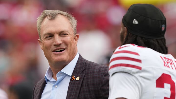 Sep 28, 2025; Santa Clara, California, USA; San Francisco 49ers general manager John Lynch (left) talks with cornerback Eli Apple (right) before the game against the Jacksonville Jaguars at Levi's Stadium. Mandatory Credit: Darren Yamashita-Imagn Images
