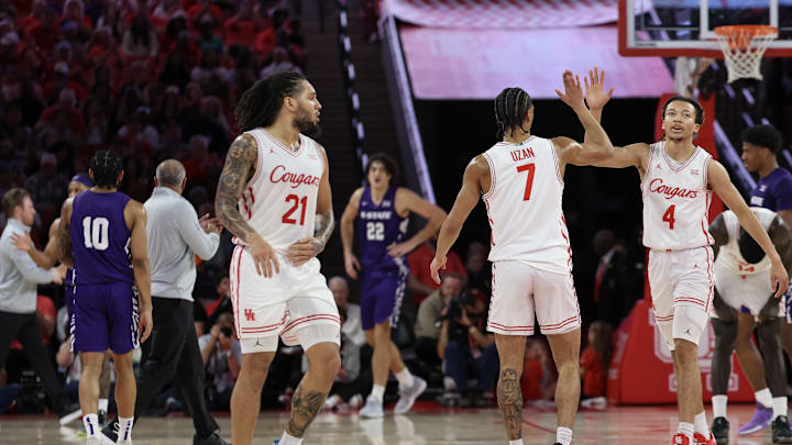 Feb 14, 2026; Houston, Texas, USA; Houston Cougars guard Kingston Flemings (4) celebrates guard Milos Uzan (7) three point basket against the Kansas State Wildcats in the first half at Fertitta Center. Mandatory Credit: Thomas Shea-Imagn Images