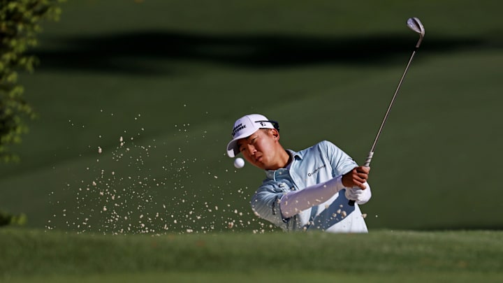 Michael Kim hits out of a bunker during a practice round at the Masters